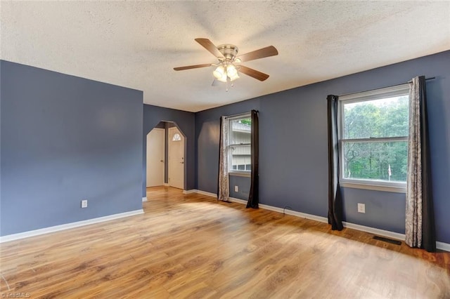 spare room featuring ceiling fan, a textured ceiling, and light hardwood / wood-style flooring