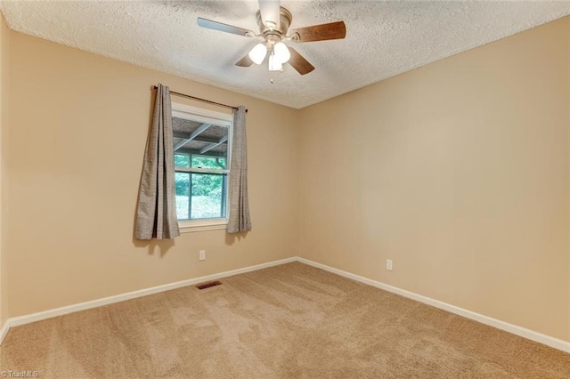 carpeted empty room featuring a textured ceiling and ceiling fan