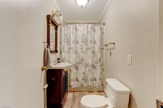 bathroom featuring vanity, wood-type flooring, walk in shower, crown molding, and toilet