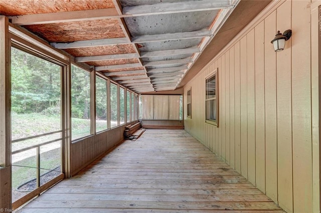 unfurnished sunroom featuring lofted ceiling