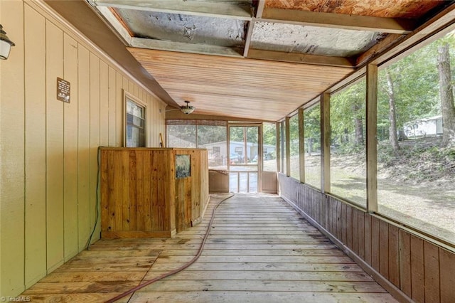 unfurnished sunroom with vaulted ceiling with beams and wood ceiling