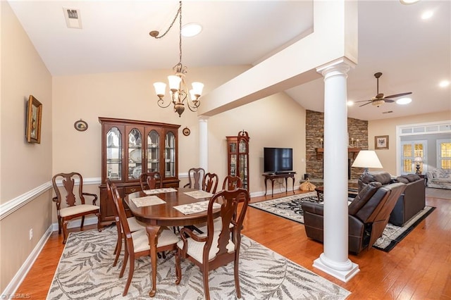 503 Sweetwater Ct, Clemmons, NC 27012 - dining room featuring light wood-style flooring, visible vents, ornate columns, ceiling fan with notable chandelier, and lofted ceiling