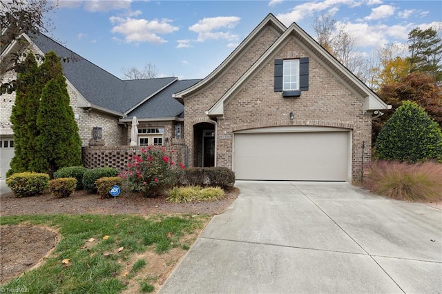 503 Sweetwater Ct, Clemmons, NC 27012 - traditional home featuring a shingled roof, driveway, and brick siding