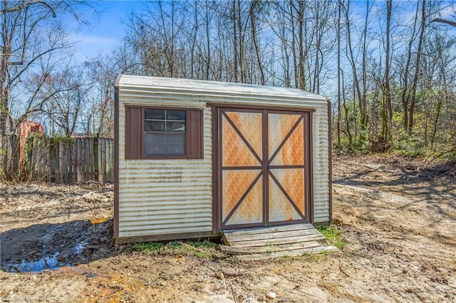 view of shed featuring fence