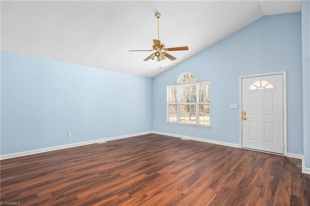 entryway featuring lofted ceiling, a textured ceiling, dark wood-style floors, baseboards, and ceiling fan