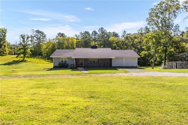 single story home with a garage and a front lawn