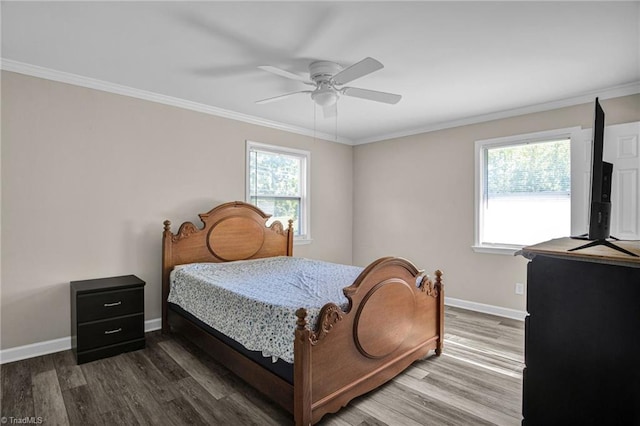 bedroom featuring ceiling fan, ornamental molding, and dark wood-type flooring