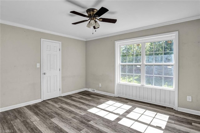 empty room featuring ceiling fan, dark hardwood / wood-style floors, and crown molding