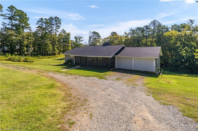 single story home featuring a garage and a front lawn