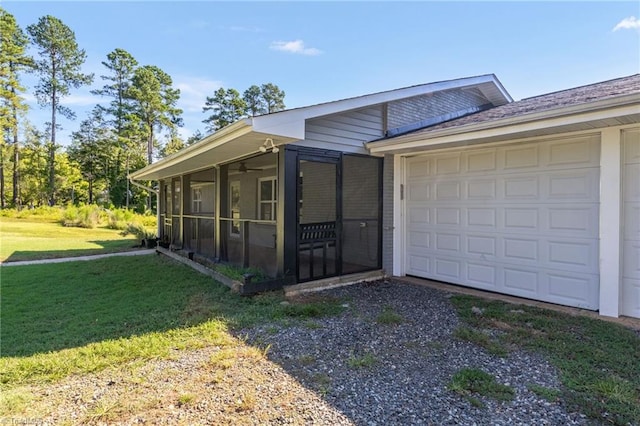 view of front facade featuring a sunroom, a garage, and a front lawn