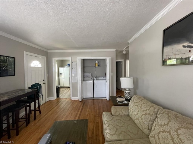 2820 Shady Lawn Dr, Greensboro, NC 27408 - living room featuring washer and clothes dryer, a textured ceiling, crown molding, and wood finished floors