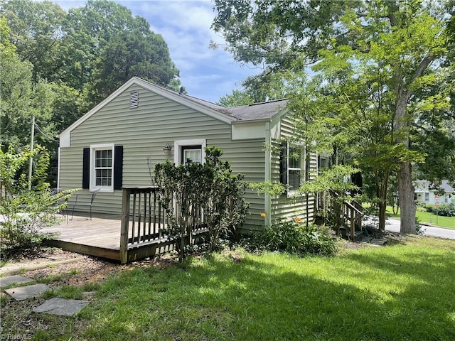 2820 Shady Lawn Dr, Greensboro, NC 27408 - rear view of house with a deck, a lawn, and roof with shingles