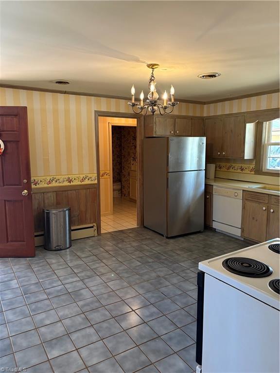 kitchen with a baseboard radiator, decorative light fixtures, light tile patterned floors, white appliances, and a notable chandelier