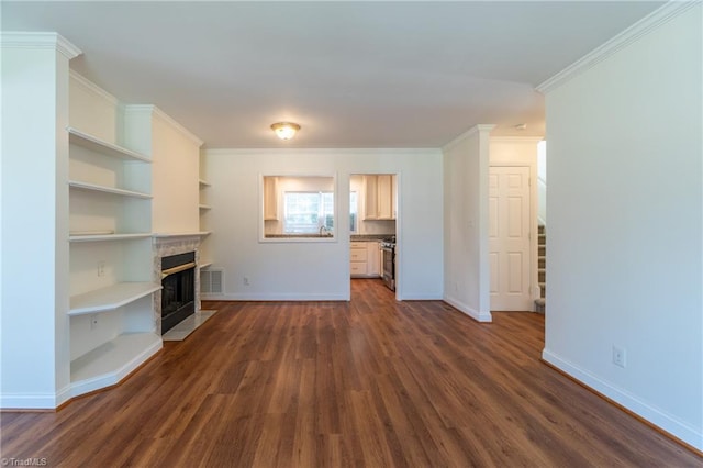 unfurnished living room with dark hardwood / wood-style floors, a tile fireplace, and ornamental molding