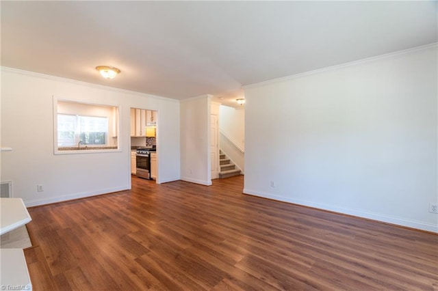 unfurnished living room with crown molding and dark hardwood / wood-style flooring