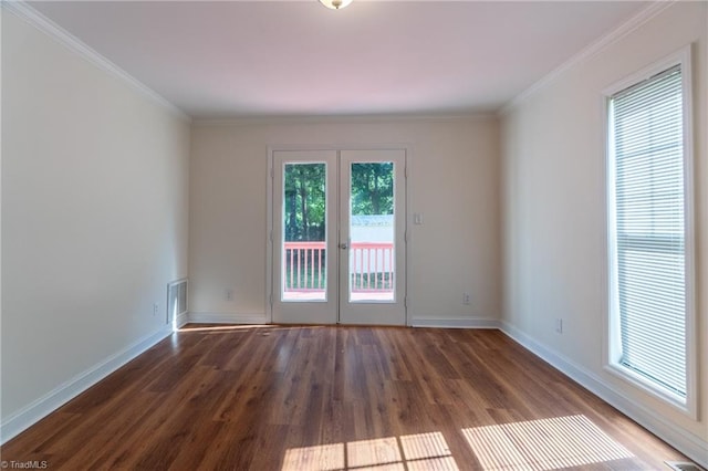 spare room with hardwood / wood-style floors, crown molding, and french doors