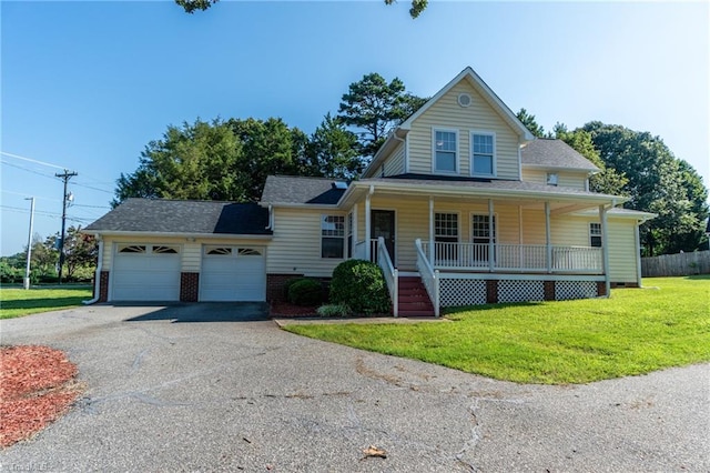 farmhouse inspired home with a front lawn, a garage, and covered porch