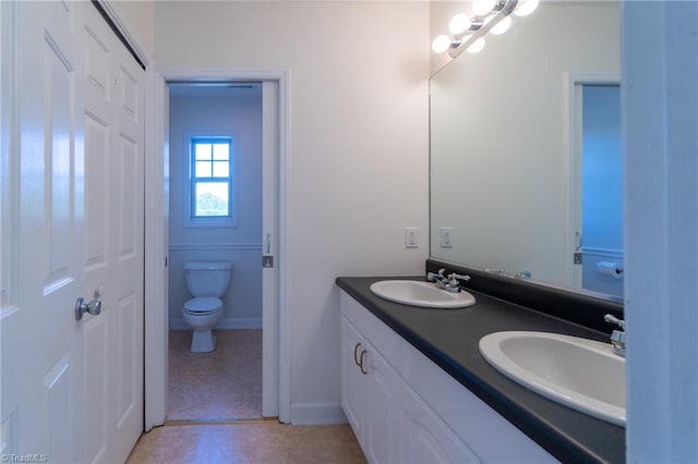 bathroom featuring tile patterned floors, toilet, and vanity