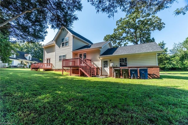 rear view of house with a lawn and a deck