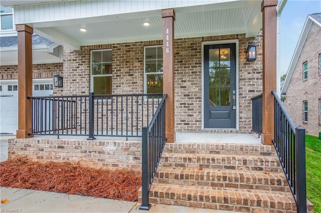 property entrance featuring a garage and a porch