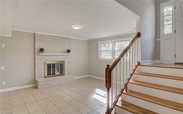 unfurnished living room featuring light tile patterned floors, a fireplace, and ornamental molding