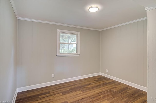 spare room featuring crown molding and dark hardwood / wood-style floors