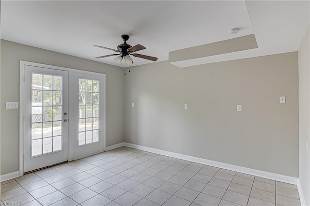 tiled spare room featuring french doors and ceiling fan