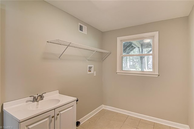 laundry area featuring washer hookup, sink, and cabinets