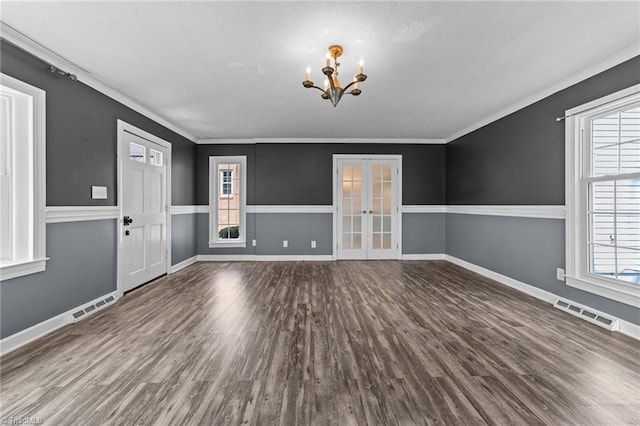 interior space featuring ornamental molding, french doors, visible vents, and wood finished floors