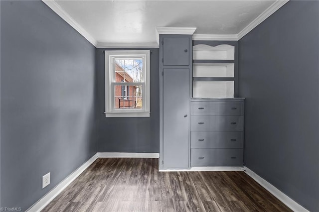 unfurnished bedroom featuring crown molding, dark wood-style floors, and baseboards