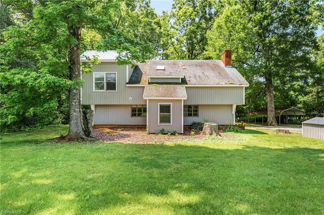 3542 Wayne White Rd, Climax, NC 27233 - back of house featuring a detached carport, a chimney, and a lawn