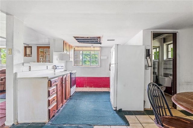 3542 Wayne White Rd, Climax, NC 27233 - kitchen with electric range oven, freestanding refrigerator, light countertops, and tile patterned floors