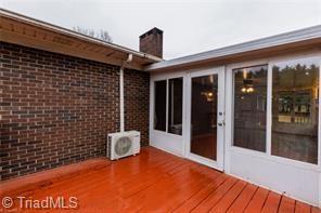 wooden deck featuring ac unit