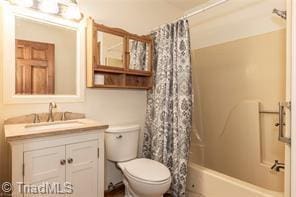 bathroom featuring shower / bath combo, vanity, and toilet