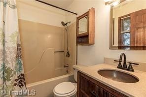 full bath with toilet, shower / bathtub combination with curtain, and vanity