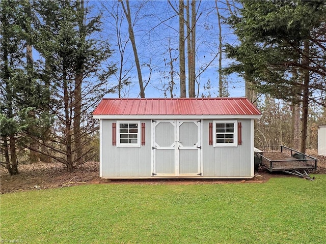 view of outbuilding with a yard