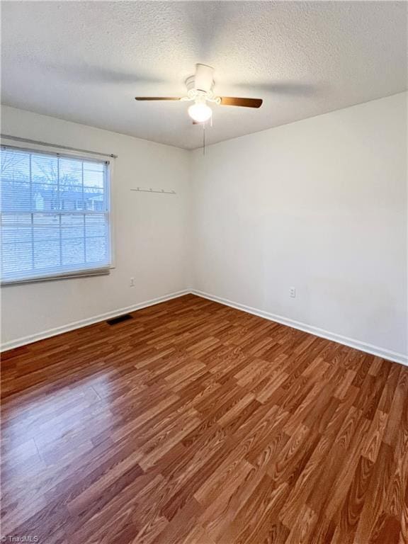 spare room with ceiling fan, hardwood / wood-style floors, and a textured ceiling