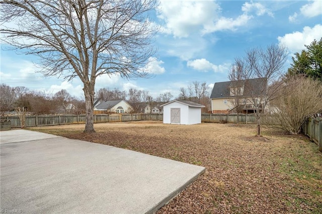 view of yard with a storage shed and a patio