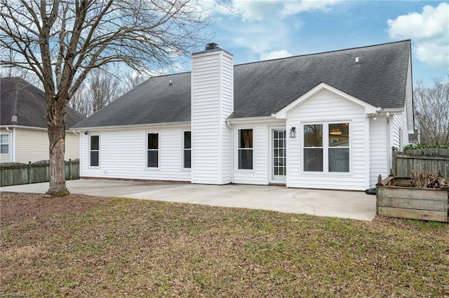 rear view of house featuring a yard and a patio