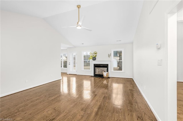 unfurnished living room featuring hardwood / wood-style floors, vaulted ceiling, and ceiling fan