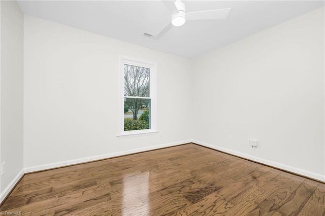 spare room with hardwood / wood-style floors and ceiling fan