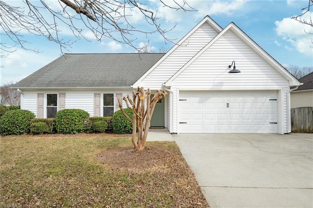 view of front of property featuring a garage and a front yard