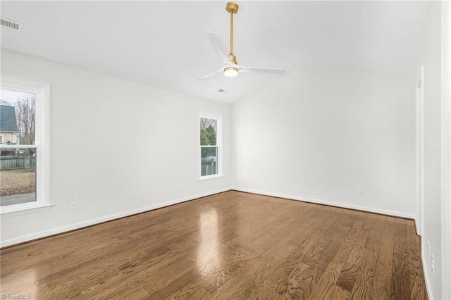 unfurnished room with hardwood / wood-style flooring, ceiling fan, and vaulted ceiling