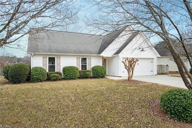 view of front of property featuring a garage and a front lawn