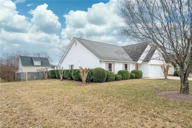 view of property exterior with a yard and a garage