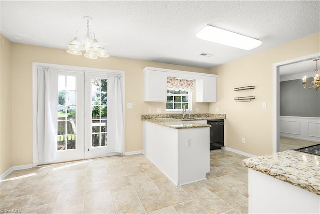 131 Hickory Creek Ct, Winston-Salem, NC 27107 - kitchen featuring a chandelier, black dishwasher, white cabinets, a peninsula, and a textured ceiling