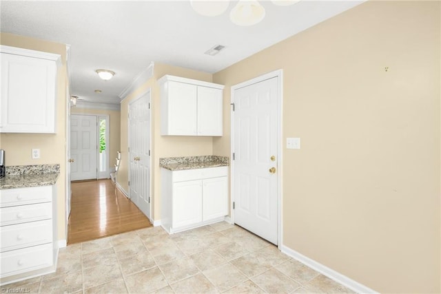 131 Hickory Creek Ct, Winston-Salem, NC 27107 - kitchen featuring white cabinetry, light stone countertops, and ornamental molding