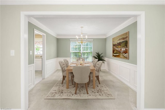 131 Hickory Creek Ct, Winston-Salem, NC 27107 - dining space with a chandelier, a decorative wall, crown molding, and light colored carpet
