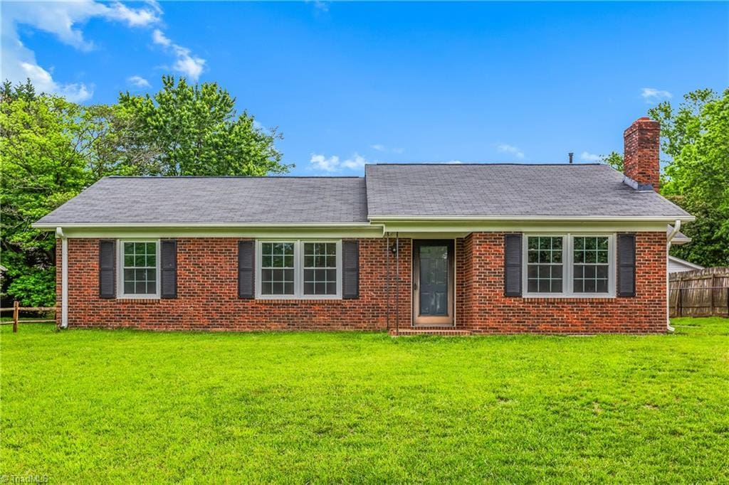 313 Cheltenham Dr, Winston-Salem, NC 27103 - view of front of property featuring a chimney, brick siding, and roof with shingles