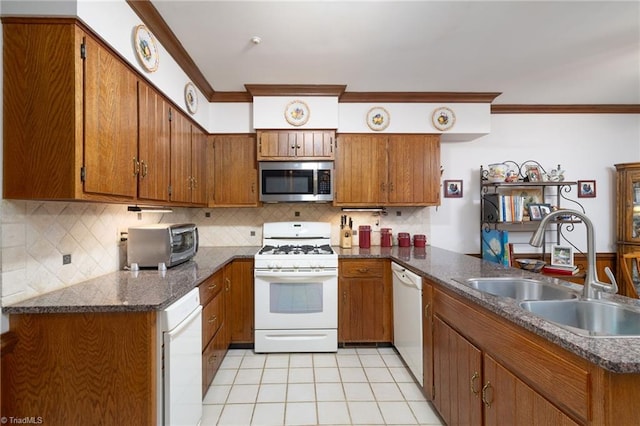 kitchen featuring light tile patterned flooring, white appliances, sink, and decorative backsplash